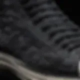 Close-up detail of intricate black embroidery on Converse shoes