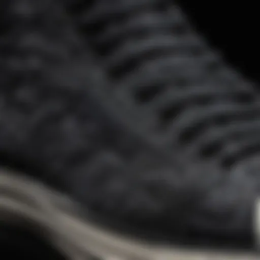 Close-up detail of intricate black embroidery on Converse shoes