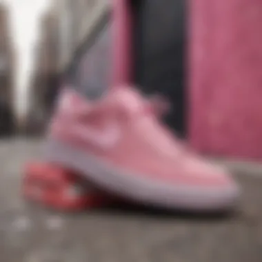 Artistic arrangement of pink suede Nike shoes against graffiti