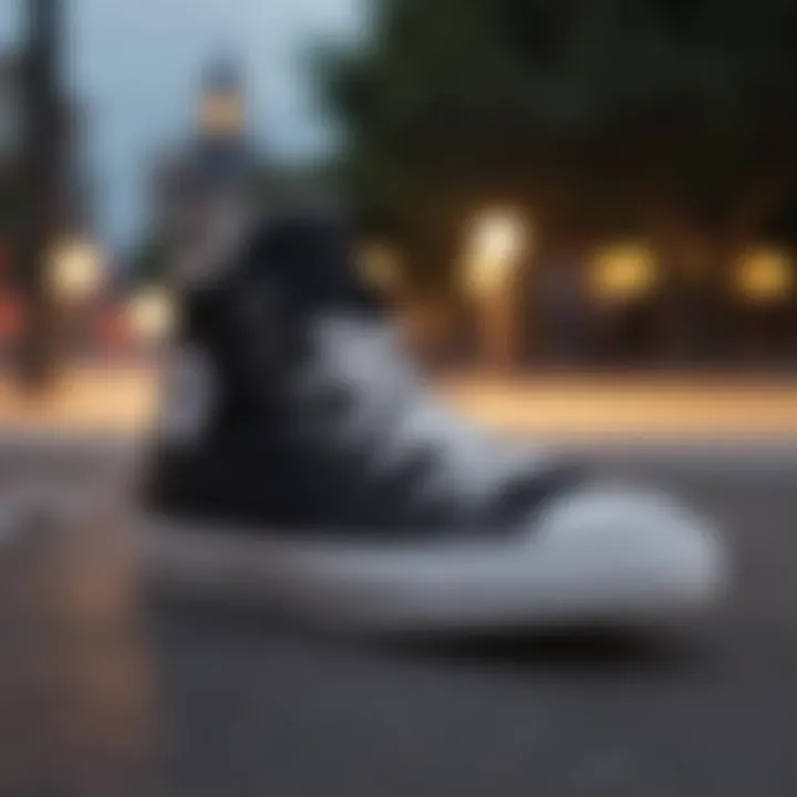 Side view of all black Converse on skateboard