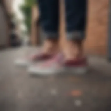 Person skateboarding while wearing embroidered Vans slip-ons in an urban setting