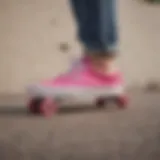 A vibrant pair of pink Vans shoes displayed on a skateboard.