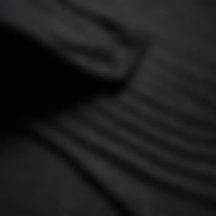 Close-up of fabric texture on a plain black hoodie worn by a skateboarder.