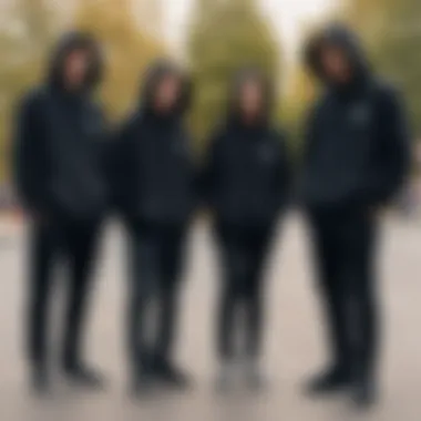 Group of skaters wearing plain black hoodies in a skate park setting.