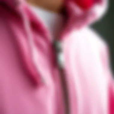 Close-up of fabric texture showcasing the quality of a pink zip-up hoodie.
