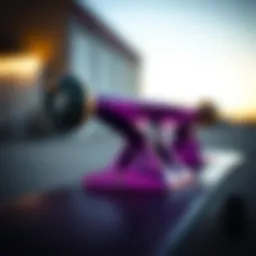 Close-up view of a purple skateboard truck showcasing its intricate design features.