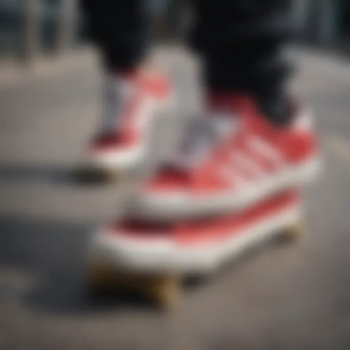 Close-up of red and white Adidas sneakers on a skateboard deck