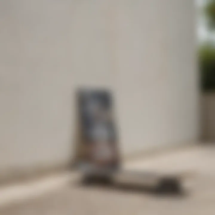 A serene outdoor scene where a skateboard rests against a wall, complementing a white graphic tee laid out nearby.